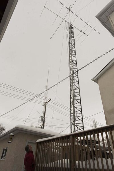 Drury looks up at his antennas tower in his backyard. His antennas allow worldwide communication. (Jesse Boily / Winnipeg Free Press)</p>